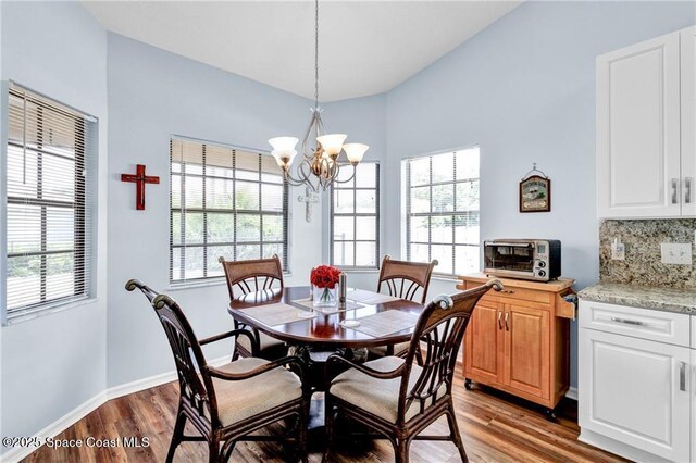 749 Tulip Dr, Sebastian, FL 32958 - dining space with light wood-style flooring, a chandelier, and baseboards