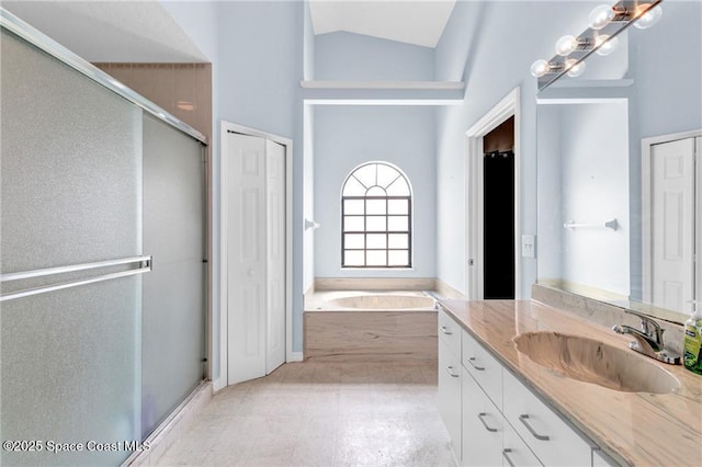 749 Tulip Dr, Sebastian, FL 32958 - bathroom with vanity, a garden tub, a stall shower, and lofted ceiling