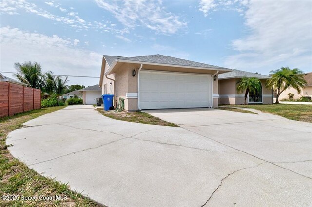 749 Tulip Dr, Sebastian, FL 32958 - view of front facade featuring driveway, an attached garage, and stucco siding