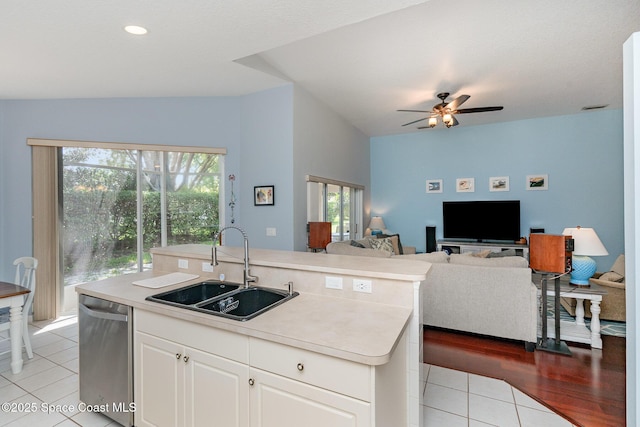 2020 Twelve Oaks Dr SE, Palm Bay, FL 32909 - kitchen featuring a sink, stainless steel dishwasher, open floor plan, light tile patterned floors, and light countertops