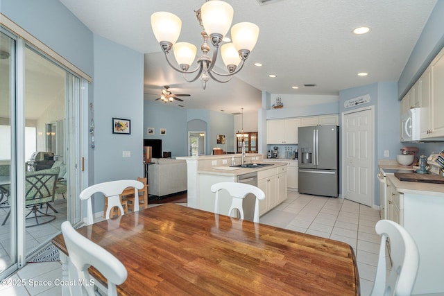2020 Twelve Oaks Dr SE, Palm Bay, FL 32909 - dining space featuring a chandelier, light tile patterned floors, a ceiling fan, vaulted ceiling, and recessed lighting