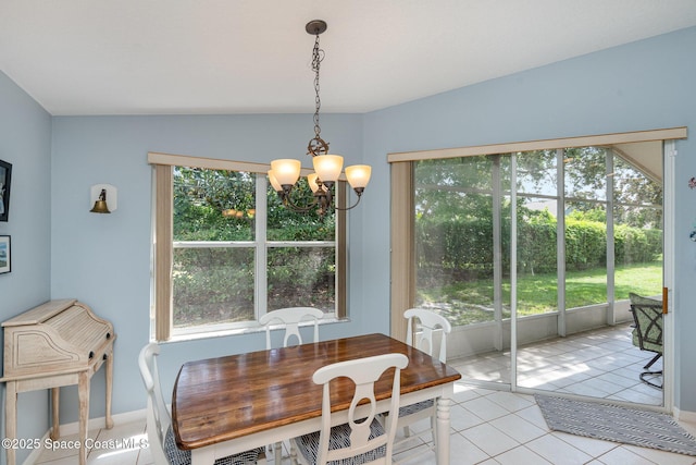 2020 Twelve Oaks Dr SE, Palm Bay, FL 32909 - dining area featuring a chandelier, plenty of natural light, light tile patterned floors, baseboards, and vaulted ceiling