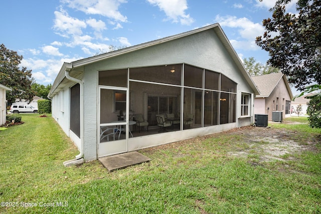 2020 Twelve Oaks Dr SE, Palm Bay, FL 32909 - rear view of property with a sunroom, central AC, and a lawn