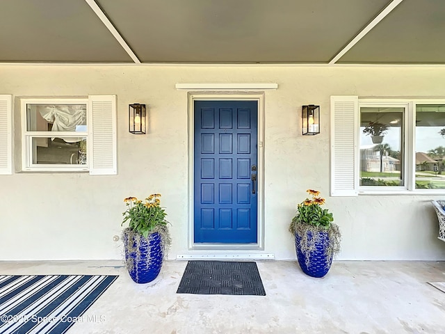 201 Woody Cir, Melbourne Beach, FL 32951 - view of exterior entry featuring stucco siding