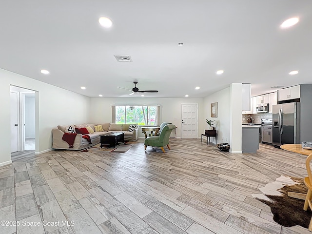 201 Woody Cir, Melbourne Beach, FL 32951 - living area with light wood-style flooring, a ceiling fan, recessed lighting, and baseboards