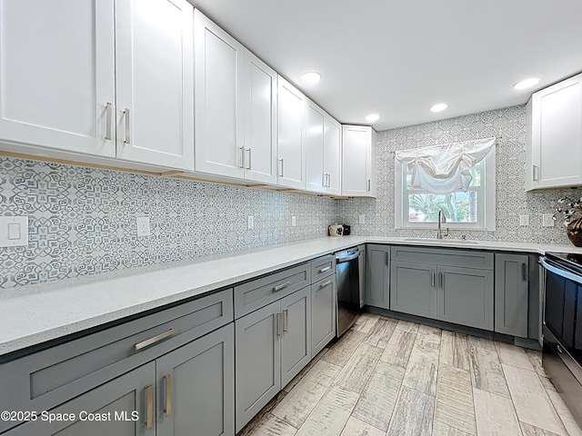 201 Woody Cir, Melbourne Beach, FL 32951 - kitchen with a sink, dishwasher, gray cabinetry, tasteful backsplash, and recessed lighting