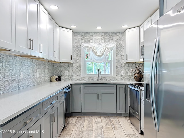 201 Woody Cir, Melbourne Beach, FL 32951 - kitchen featuring stainless steel appliances, a sink, gray cabinets, recessed lighting, and tasteful backsplash