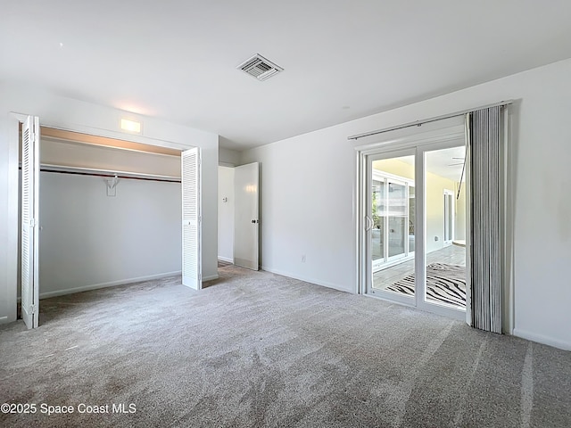 201 Woody Cir, Melbourne Beach, FL 32951 - unfurnished bedroom featuring carpet, access to exterior, baseboards, and a closet