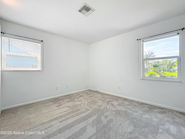 201 Woody Cir, Melbourne Beach, FL 32951 - carpeted spare room with plenty of natural light and baseboards