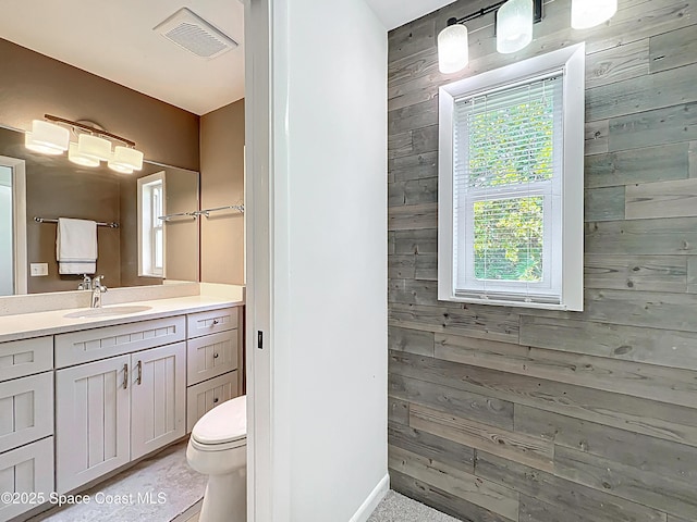 201 Woody Cir, Melbourne Beach, FL 32951 - full bathroom featuring wooden walls, vanity, toilet, and baseboards