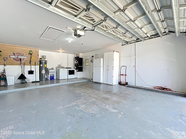 201 Woody Cir, Melbourne Beach, FL 32951 - garage with freestanding refrigerator, separate washer and dryer, water heater, and a garage door opener