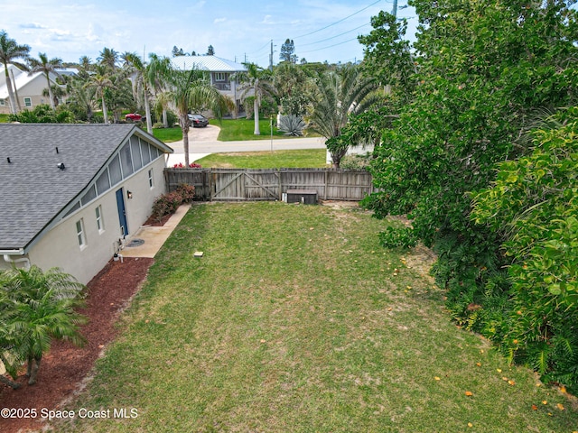 201 Woody Cir, Melbourne Beach, FL 32951 - view of yard featuring a gate and central air condition unit