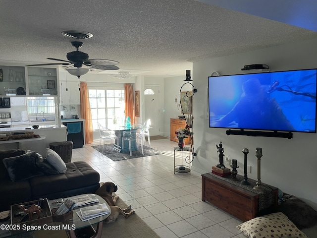 610 Buttonwood Dr, Merritt Island, FL 32953 - living room featuring light tile patterned flooring, a textured ceiling, and a ceiling fan