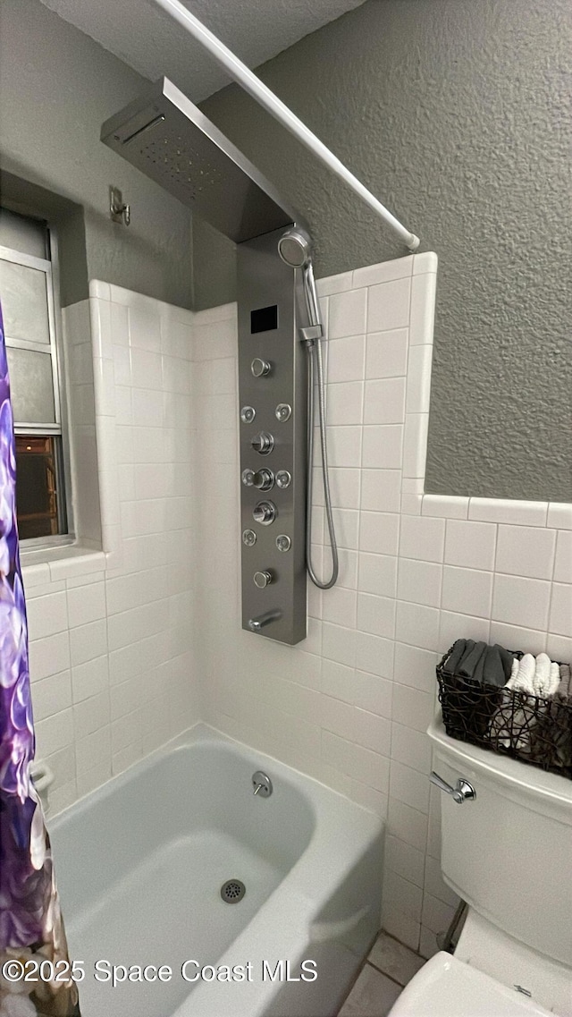 610 Buttonwood Dr, Merritt Island, FL 32953 - bathroom with shower / tub combo, tile walls, a textured wall, and toilet