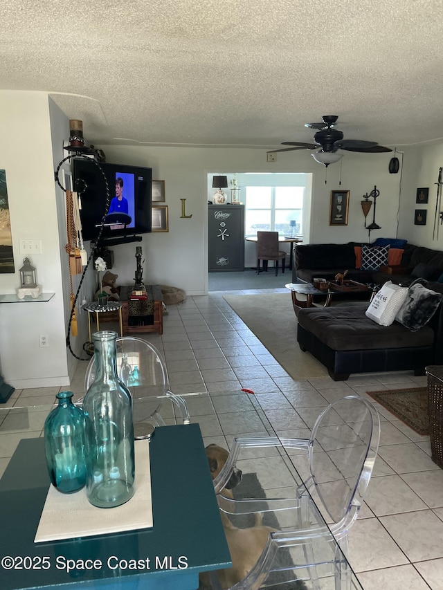610 Buttonwood Dr, Merritt Island, FL 32953 - tiled living room with a ceiling fan and a textured ceiling