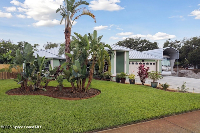 4625 Curtis Blvd, Cocoa, FL 32927 - view of front of home featuring a detached carport, metal roof, and driveway