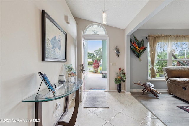 4625 Curtis Blvd, Cocoa, FL 32927 - entrance foyer featuring light tile patterned floors, baseboards, and lofted ceiling