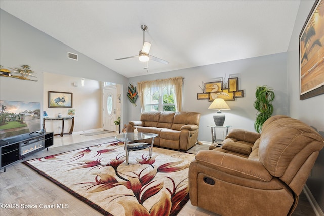 4625 Curtis Blvd, Cocoa, FL 32927 - living room featuring lofted ceiling, a ceiling fan, light wood finished floors, and baseboards