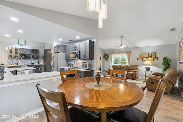 4625 Curtis Blvd, Cocoa, FL 32927 - dining area featuring light wood-type flooring, ceiling fan, baseboards, lofted ceiling, and recessed lighting