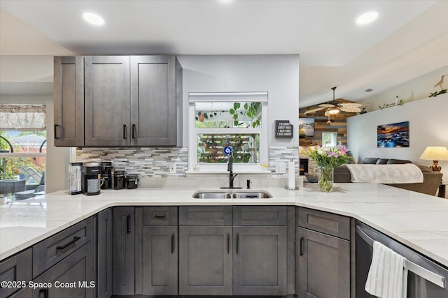 4625 Curtis Blvd, Cocoa, FL 32927 - kitchen featuring a sink, light stone countertops, a peninsula, backsplash, and lofted ceiling