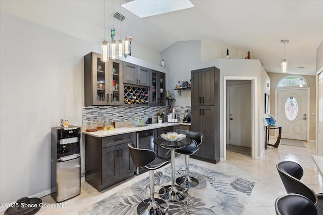 4625 Curtis Blvd, Cocoa, FL 32927 - indoor bar featuring a skylight, decorative backsplash, vaulted ceiling, decorative light fixtures, and beverage cooler