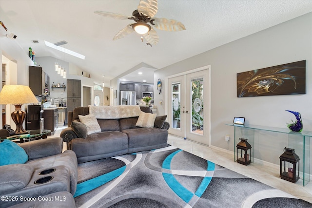 4625 Curtis Blvd, Cocoa, FL 32927 - living area featuring light tile patterned floors, ceiling fan, lofted ceiling, a skylight, and french doors