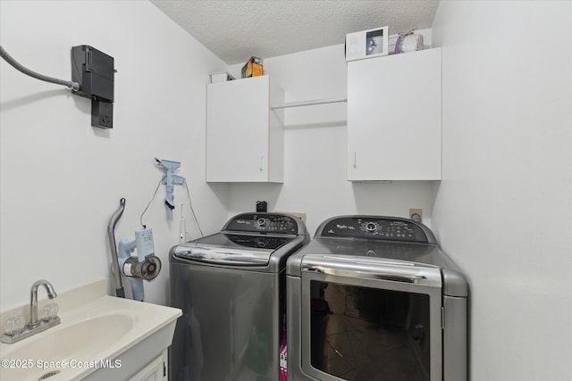 4625 Curtis Blvd, Cocoa, FL 32927 - laundry area featuring cabinet space, washer and dryer, and a textured ceiling