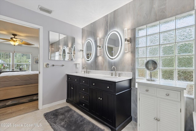 4625 Curtis Blvd, Cocoa, FL 32927 - bathroom featuring double vanity, ceiling fan, tile patterned floors, and baseboards