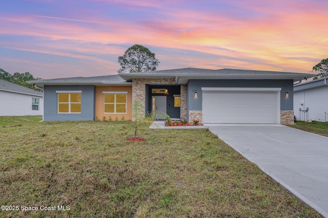 123 Garylind St SW, Palm Bay, FL 32908 - prairie-style house with an attached garage, driveway, a front lawn, and stone siding
