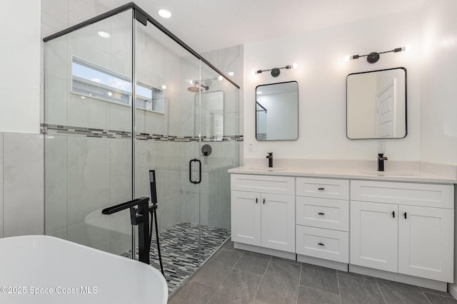 123 Garylind St SW, Palm Bay, FL 32908 - bathroom featuring a freestanding bath, a shower stall, and double vanity
