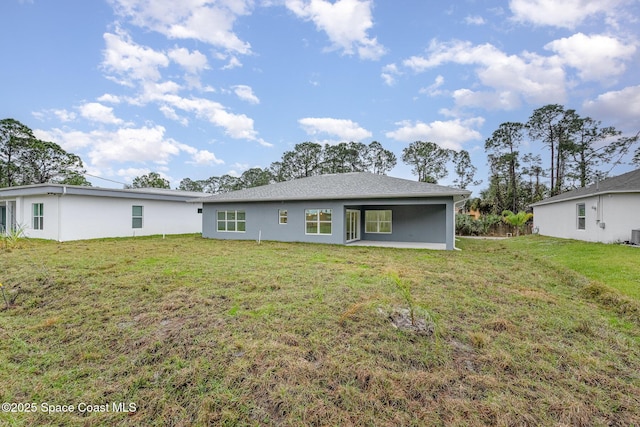 123 Garylind St SW, Palm Bay, FL 32908 - back of property featuring a lawn and stucco siding