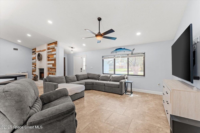 2350 Fallon Blvd NE, Palm Bay, FL 32907 - living area featuring vaulted ceiling, a ceiling fan, recessed lighting, a large fireplace, and baseboards