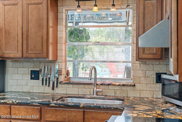 2350 Fallon Blvd NE, Palm Bay, FL 32907 - kitchen featuring a sink, brown cabinets, dark stone counters, and stainless steel microwave