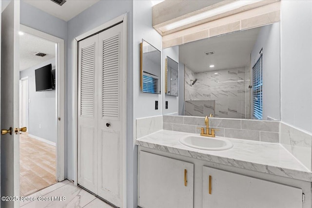 2350 Fallon Blvd NE, Palm Bay, FL 32907 - bathroom with a closet, vanity, a marble finish shower, and marble look tile flooring