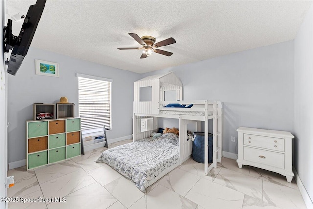 2350 Fallon Blvd NE, Palm Bay, FL 32907 - bedroom with marble look tiles, baseboards, a ceiling fan, and a textured ceiling