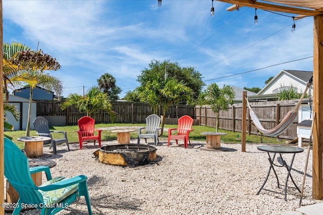 2350 Fallon Blvd NE, Palm Bay, FL 32907 - fenced backyard with an outdoor fire pit and a patio area