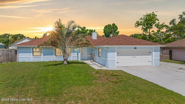 2350 Fallon Blvd NE, Palm Bay, FL 32907 - single story home with stucco siding, a chimney, an attached garage, and driveway