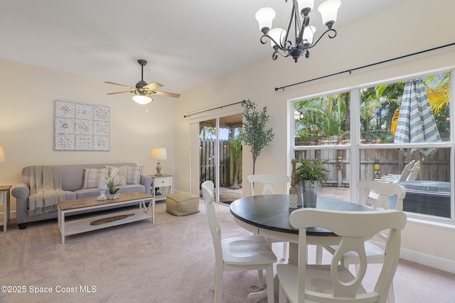7961 Evelyn Ct, Cape Canaveral, FL 32920 - dining area featuring light colored carpet, a chandelier, and a ceiling fan