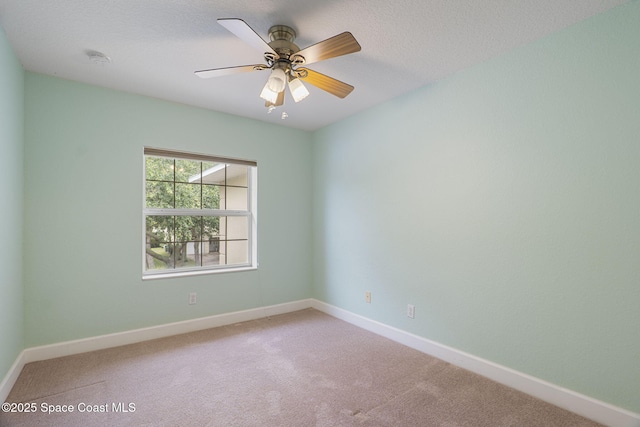 7961 Evelyn Ct, Cape Canaveral, FL 32920 - spare room featuring carpet flooring, baseboards, a smoke detector, and a ceiling fan