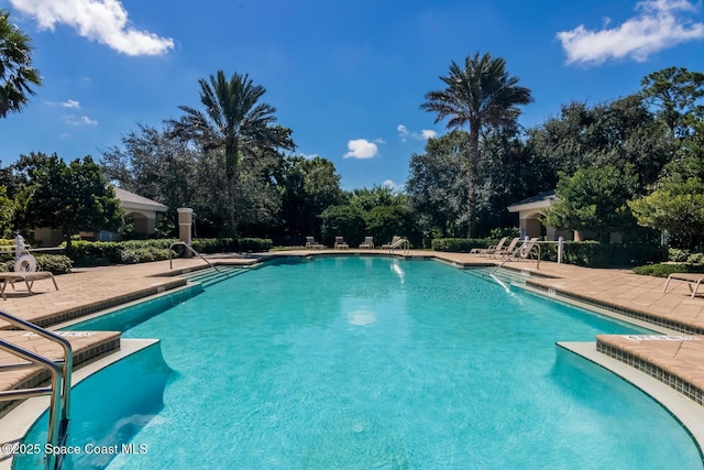 3868 Lexmark Ln Unit 205, Rockledge, FL 32955 - community pool featuring a patio and view of scattered trees