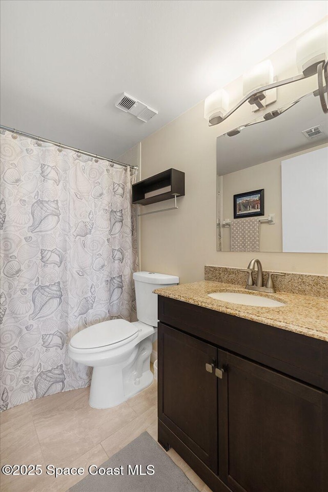 4100 Ocean Beach Blvd Unit 210, Cocoa Beach, FL 32931 - full bathroom featuring toilet, vanity, and tile patterned floors