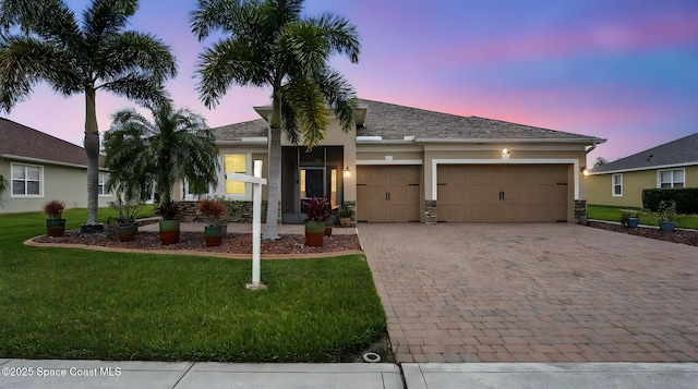 5852 Goleta Cir, Melbourne, FL 32940 - ranch-style home featuring decorative driveway, an attached garage, a yard, and stucco siding