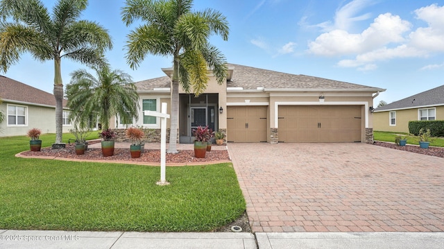 5852 Goleta Cir, Melbourne, FL 32940 - single story home with stucco siding, decorative driveway, a garage, and a front yard
