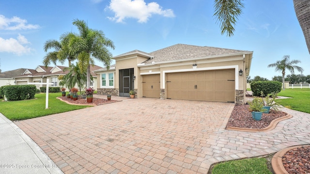5852 Goleta Cir, Melbourne, FL 32940 - view of front of property featuring stucco siding, stone siding, decorative driveway, and a front lawn