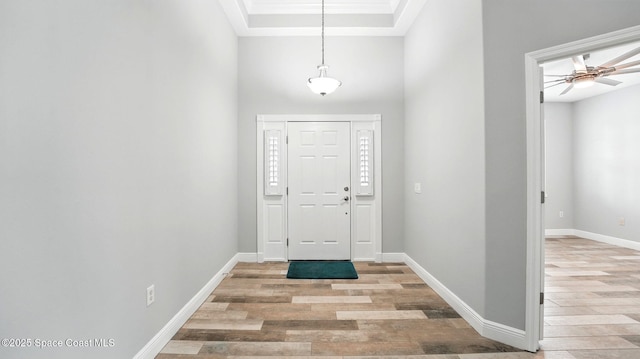 5852 Goleta Cir, Melbourne, FL 32940 - foyer entrance with light wood-style floors, baseboards, a high ceiling, and a ceiling fan