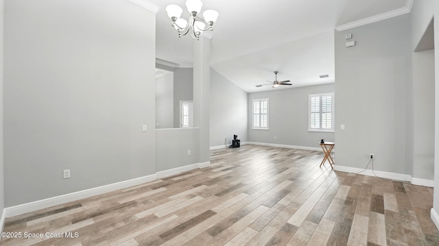 5852 Goleta Cir, Melbourne, FL 32940 - unfurnished living room with baseboards, a chandelier, light wood-style floors, vaulted ceiling, and ceiling fan