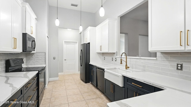 5852 Goleta Cir, Melbourne, FL 32940 - kitchen featuring black appliances, white cabinetry, a sink, light stone countertops, and tasteful backsplash