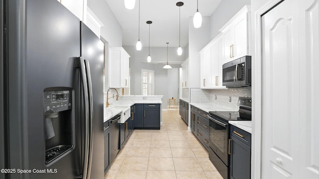 5852 Goleta Cir, Melbourne, FL 32940 - kitchen featuring stainless steel appliances, white cabinets, decorative backsplash, and decorative light fixtures