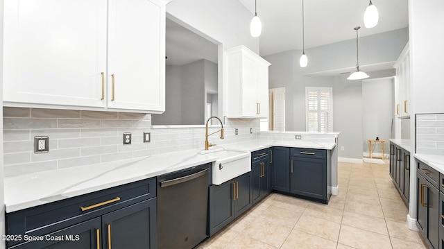 5852 Goleta Cir, Melbourne, FL 32940 - kitchen featuring dishwasher, a sink, white cabinetry, decorative backsplash, and a peninsula