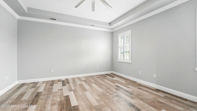 5852 Goleta Cir, Melbourne, FL 32940 - unfurnished room with a tray ceiling, ceiling fan, light wood-style flooring, baseboards, and crown molding
